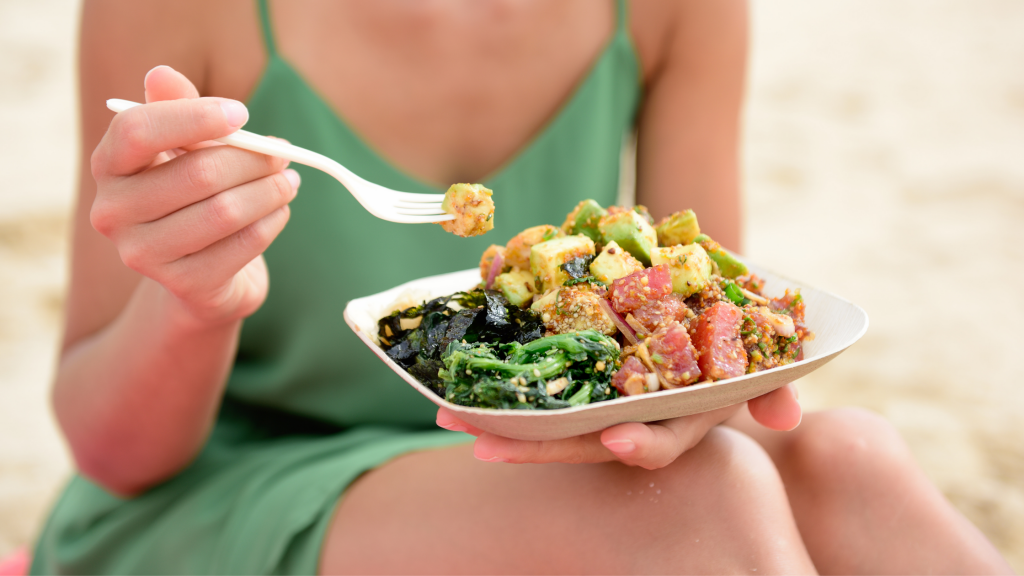 Woman holding a fresh plate of poke