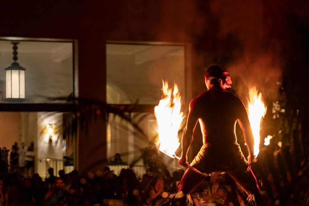 'Aha 'Aina fire dancer holding two flaming rods
