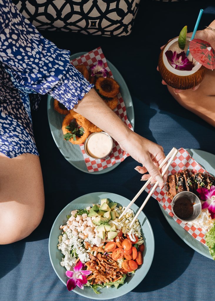 sample of the food at Splash Bar, featuring onion rings, cobb salad, and other bites.